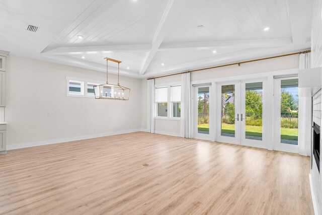 unfurnished living room featuring light wood-style floors, french doors, and baseboards