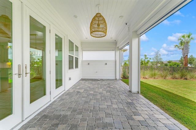 unfurnished sunroom with wooden ceiling