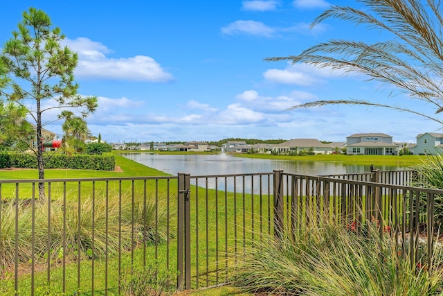 water view with a residential view and fence