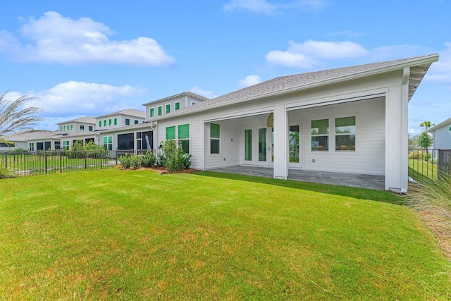 rear view of property with fence and a yard