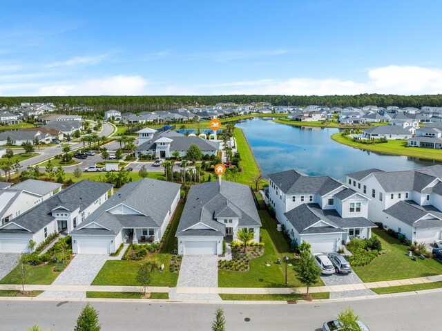 birds eye view of property with a residential view and a water view