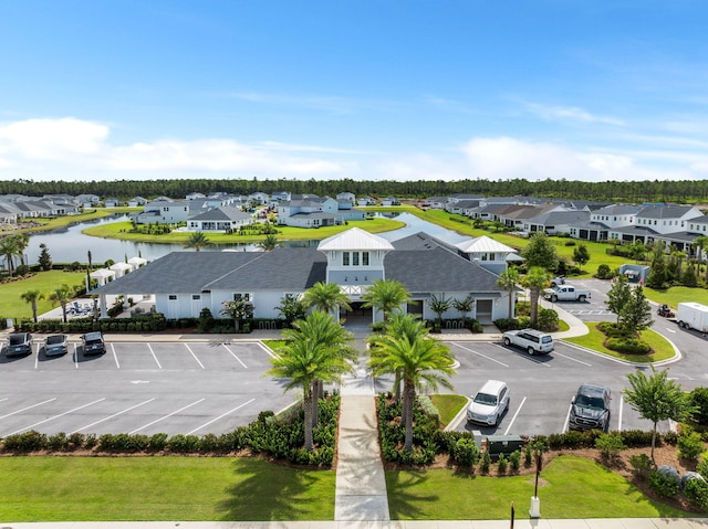 bird's eye view featuring a water view and a residential view