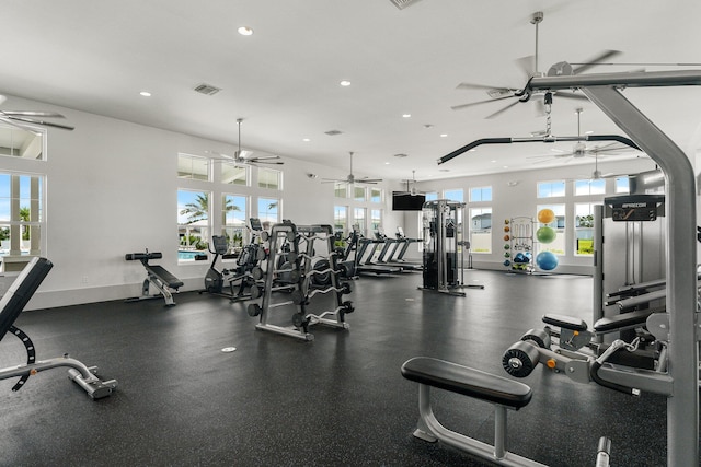 exercise room with baseboards, visible vents, a wealth of natural light, and recessed lighting