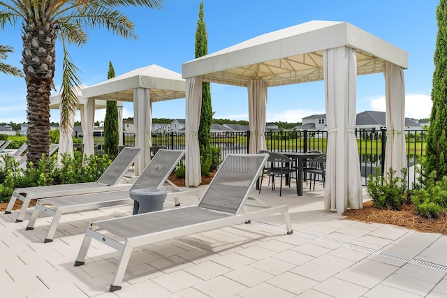 view of patio with fence and a gazebo