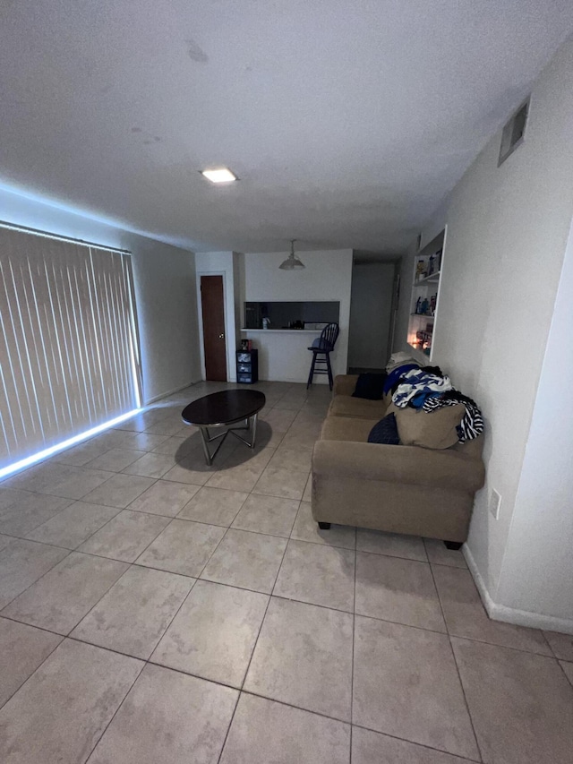 tiled living room with a textured ceiling