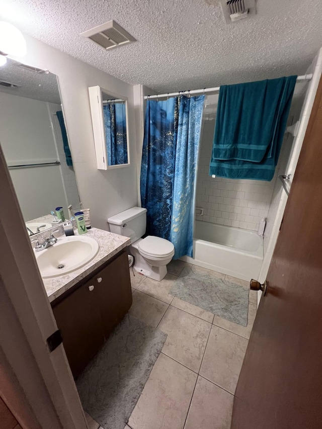 full bathroom with shower / tub combo with curtain, toilet, a textured ceiling, vanity, and tile patterned flooring