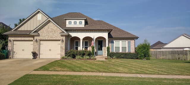 view of front of house featuring a garage and a front lawn