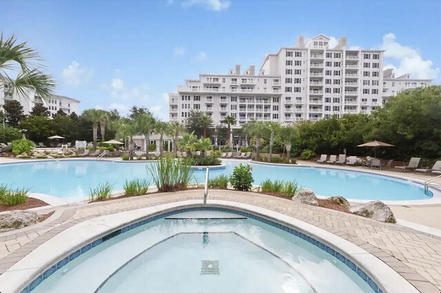 view of swimming pool with a hot tub