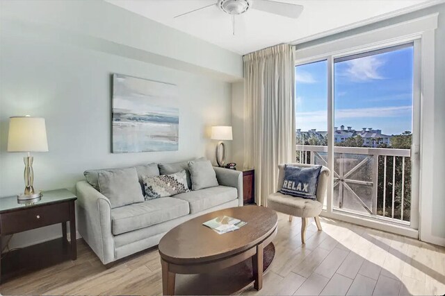 living room featuring ceiling fan and light hardwood / wood-style flooring