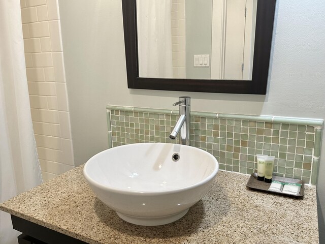 bathroom featuring vanity and tile walls