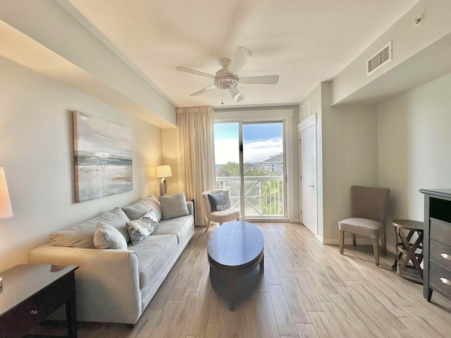 living room with light wood-type flooring and ceiling fan