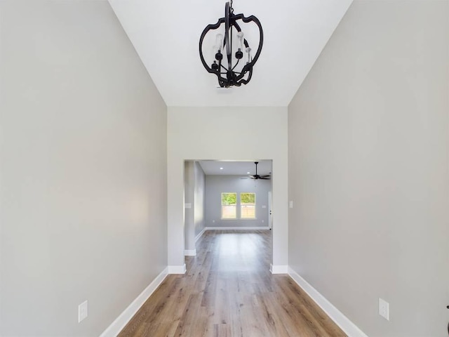 hall featuring a notable chandelier and light wood-type flooring