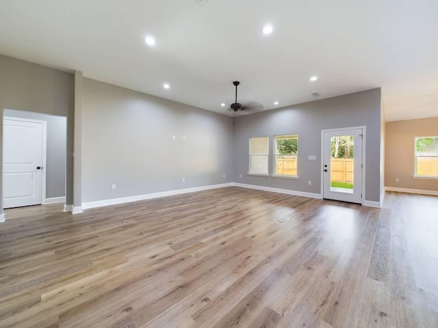 unfurnished living room with ceiling fan, baseboards, wood finished floors, and recessed lighting