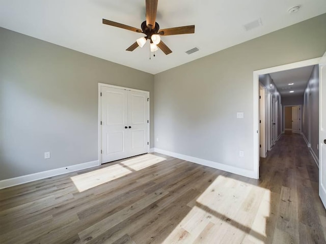 interior space with ceiling fan and hardwood / wood-style floors