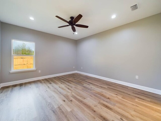 spare room featuring ceiling fan and light wood-type flooring