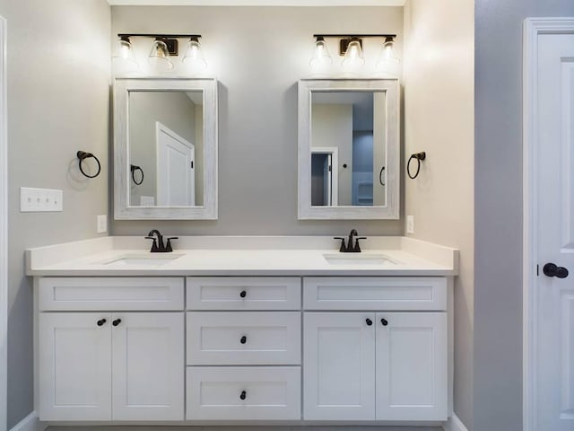 full bathroom with a sink and double vanity