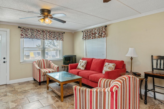 living room featuring a textured ceiling, ceiling fan, and crown molding