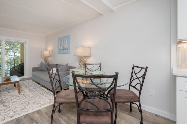 dining space with wood-type flooring