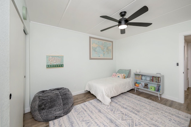 bedroom with ceiling fan, ornamental molding, and hardwood / wood-style flooring