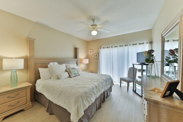 bedroom featuring ceiling fan, access to exterior, light hardwood / wood-style flooring, and a textured ceiling