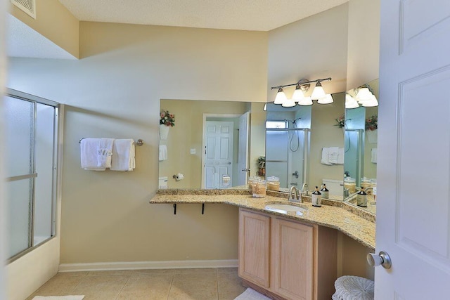 bathroom featuring tile patterned flooring, vanity, and bath / shower combo with glass door