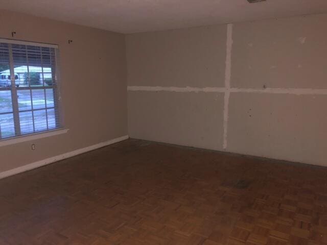 unfurnished room featuring baseboards