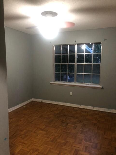 empty room featuring baseboards