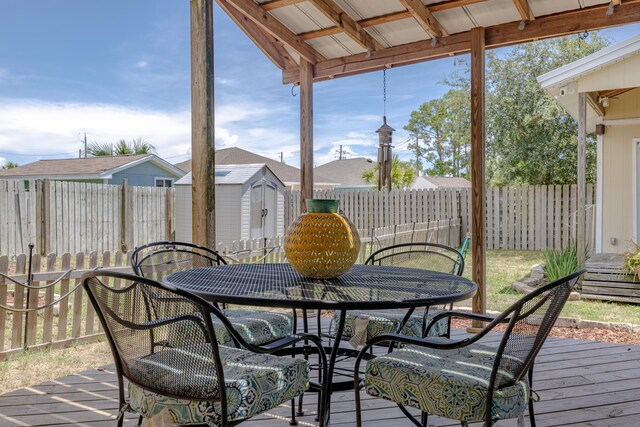 wooden deck featuring a storage unit