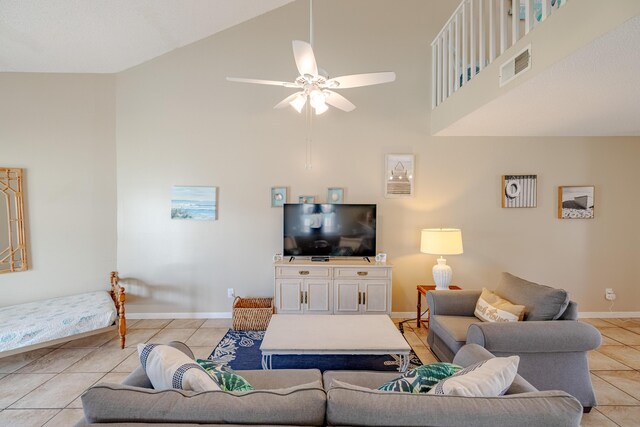 living room featuring high vaulted ceiling, ceiling fan, and light tile patterned floors