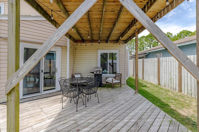 wooden deck with a grill