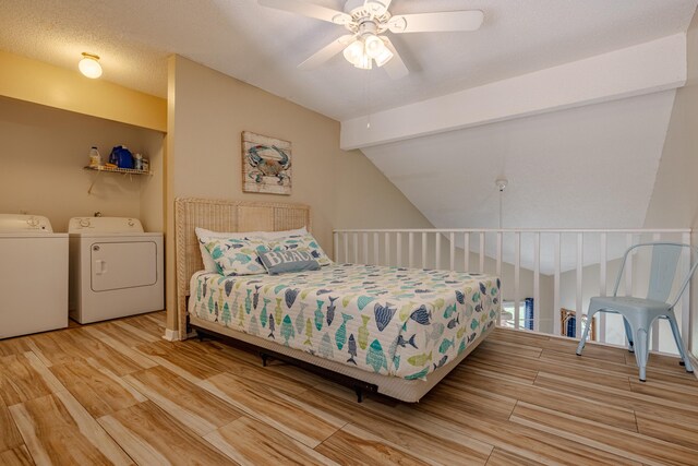 bedroom with light wood-type flooring, a textured ceiling, ceiling fan, washing machine and dryer, and lofted ceiling with beams