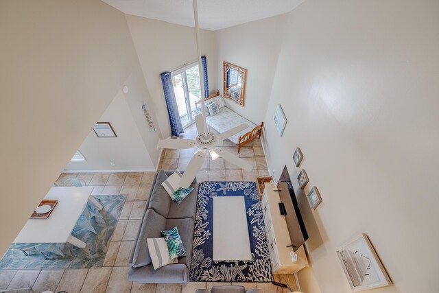 living room with light tile patterned floors and high vaulted ceiling