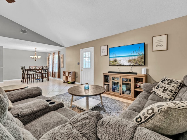 tiled living room with lofted ceiling and a chandelier