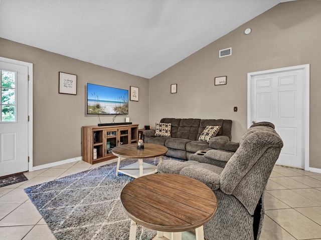 tiled living room featuring vaulted ceiling