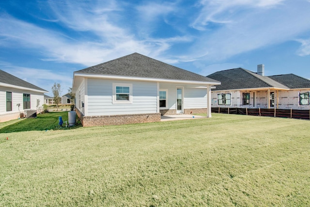 rear view of house with a lawn