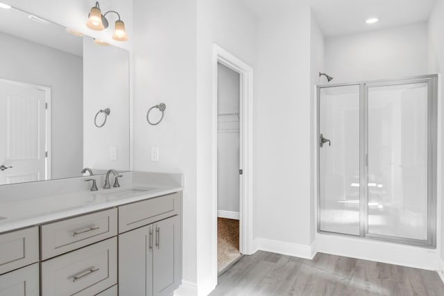 bathroom featuring vanity, hardwood / wood-style floors, and an enclosed shower