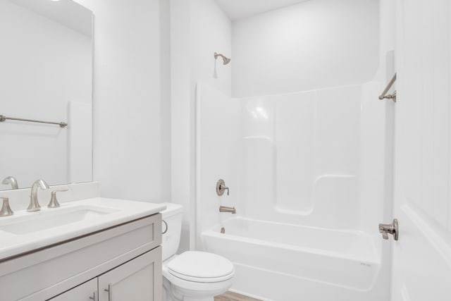 full bathroom featuring vanity, wood-type flooring, bathing tub / shower combination, and toilet