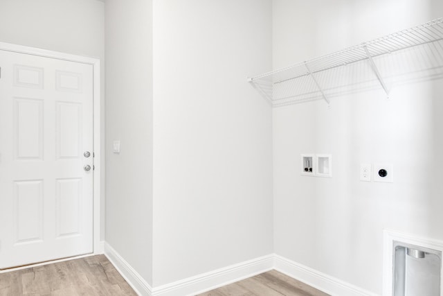 laundry room featuring electric dryer hookup, hookup for a washing machine, and light hardwood / wood-style floors