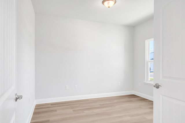 empty room with light hardwood / wood-style flooring