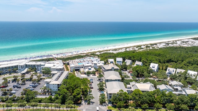drone / aerial view featuring a water view and a beach view