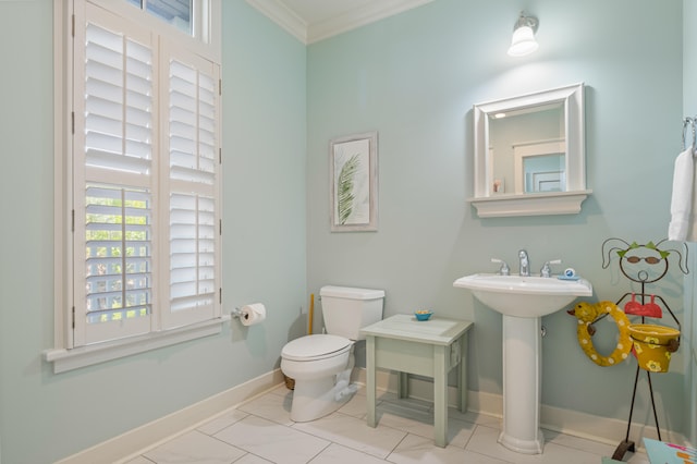 bathroom with sink, toilet, crown molding, and tile patterned flooring