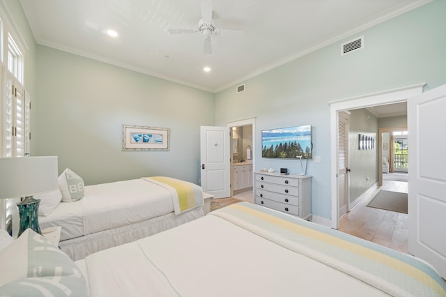 bedroom with light hardwood / wood-style floors, crown molding, ensuite bathroom, and ceiling fan