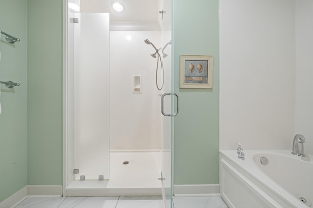 bathroom with tile patterned flooring and shower with separate bathtub