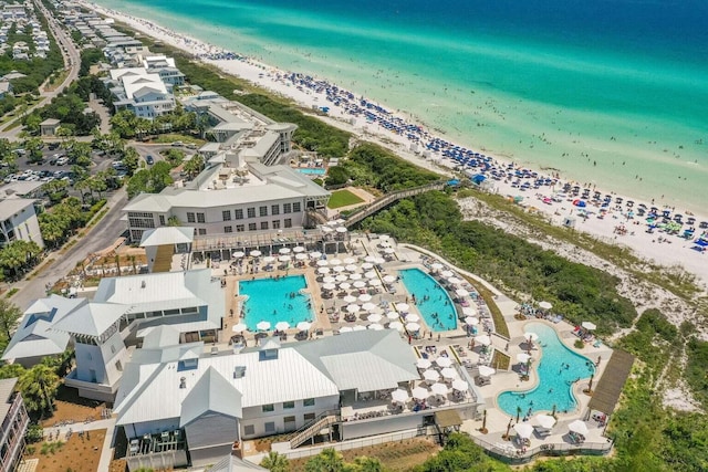 bird's eye view with a water view and a beach view