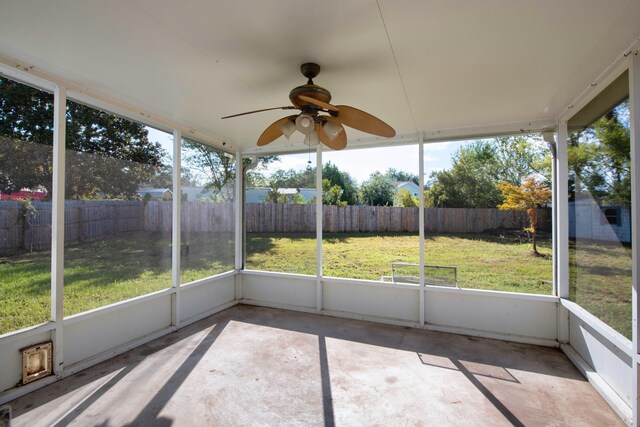 unfurnished sunroom featuring a ceiling fan