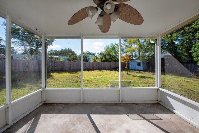 unfurnished sunroom featuring a wealth of natural light and ceiling fan