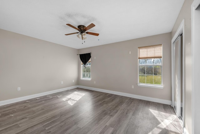 unfurnished room with ceiling fan, baseboards, and wood finished floors