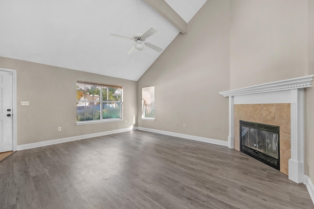 unfurnished living room with a fireplace, hardwood / wood-style floors, ceiling fan, high vaulted ceiling, and beam ceiling