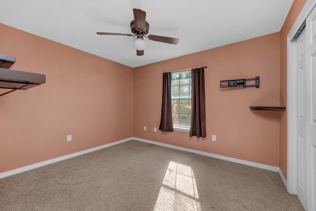 unfurnished bedroom featuring carpet floors, a ceiling fan, baseboards, and a closet