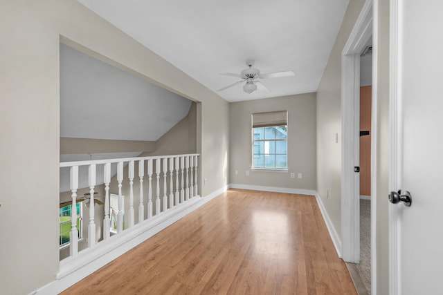 additional living space featuring ceiling fan, vaulted ceiling, and hardwood / wood-style flooring